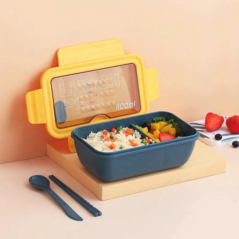 Green four-layer partitioned plastic bento box with lid, showing separate food compartments.