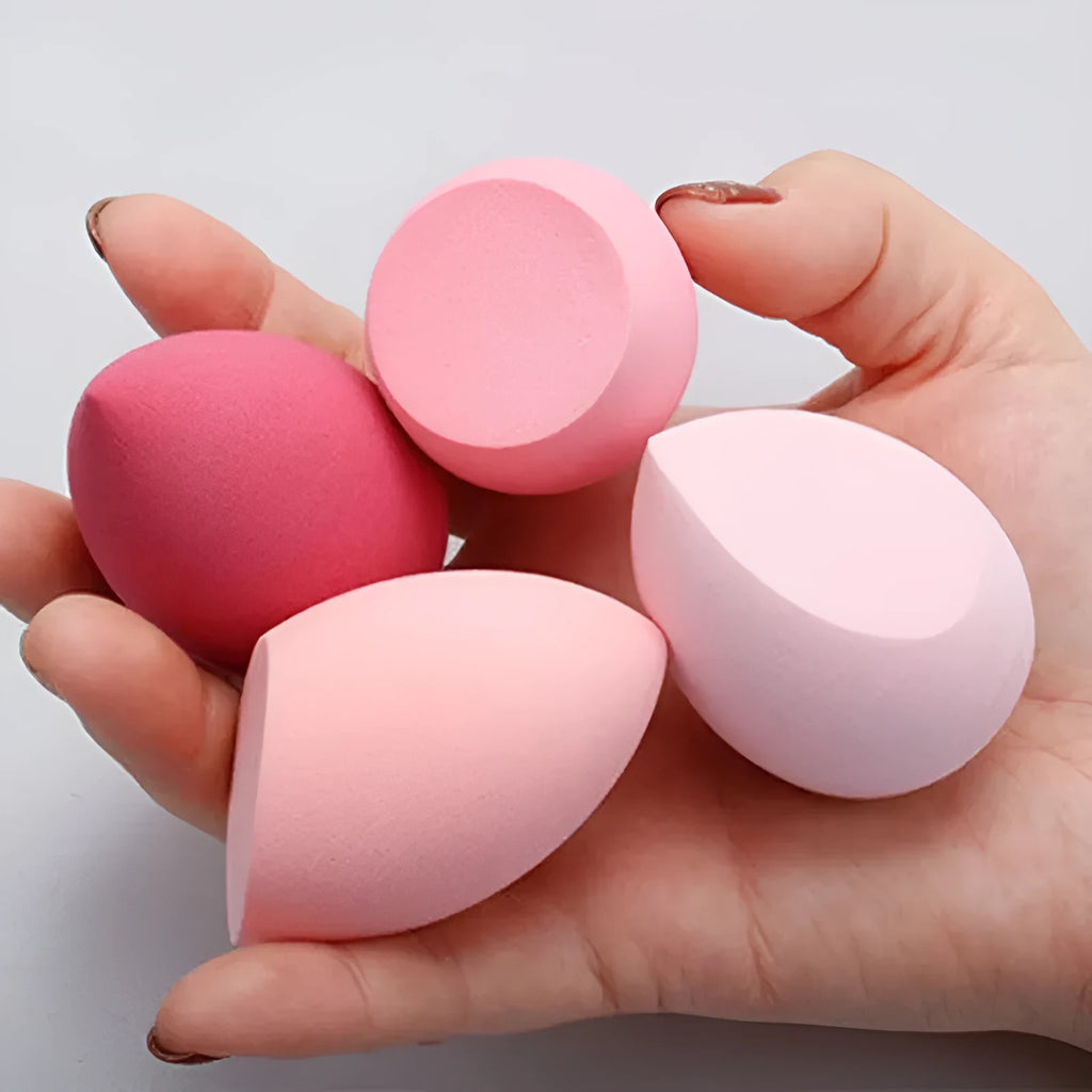 Seven different shaped makeup sponge puffs in various colours including pink, blue and burgundy