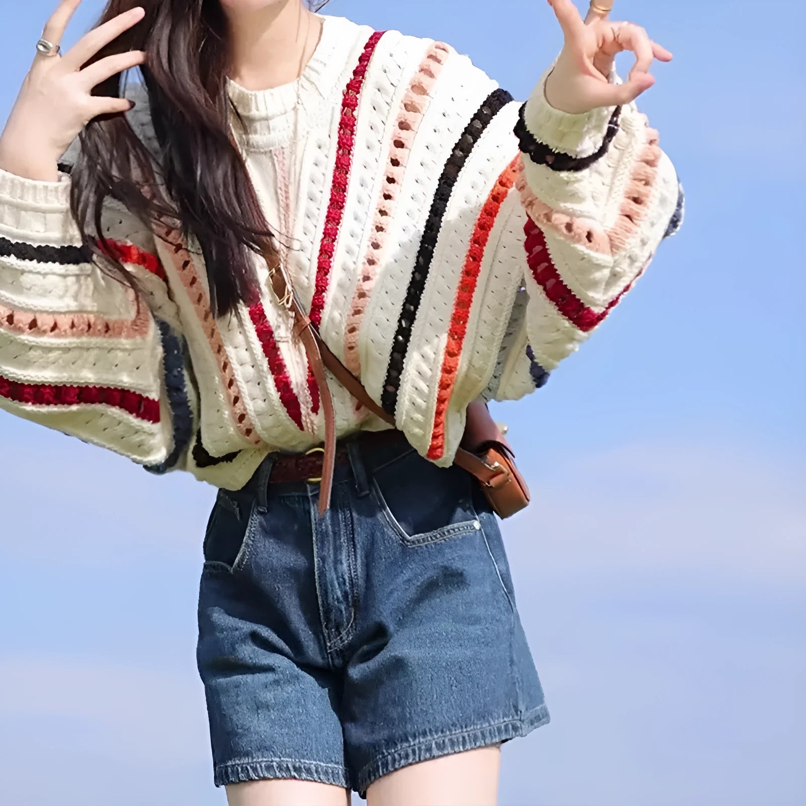 Multicolour rainbow striped women's sweater with batwing sleeves and a loose round neck fit.