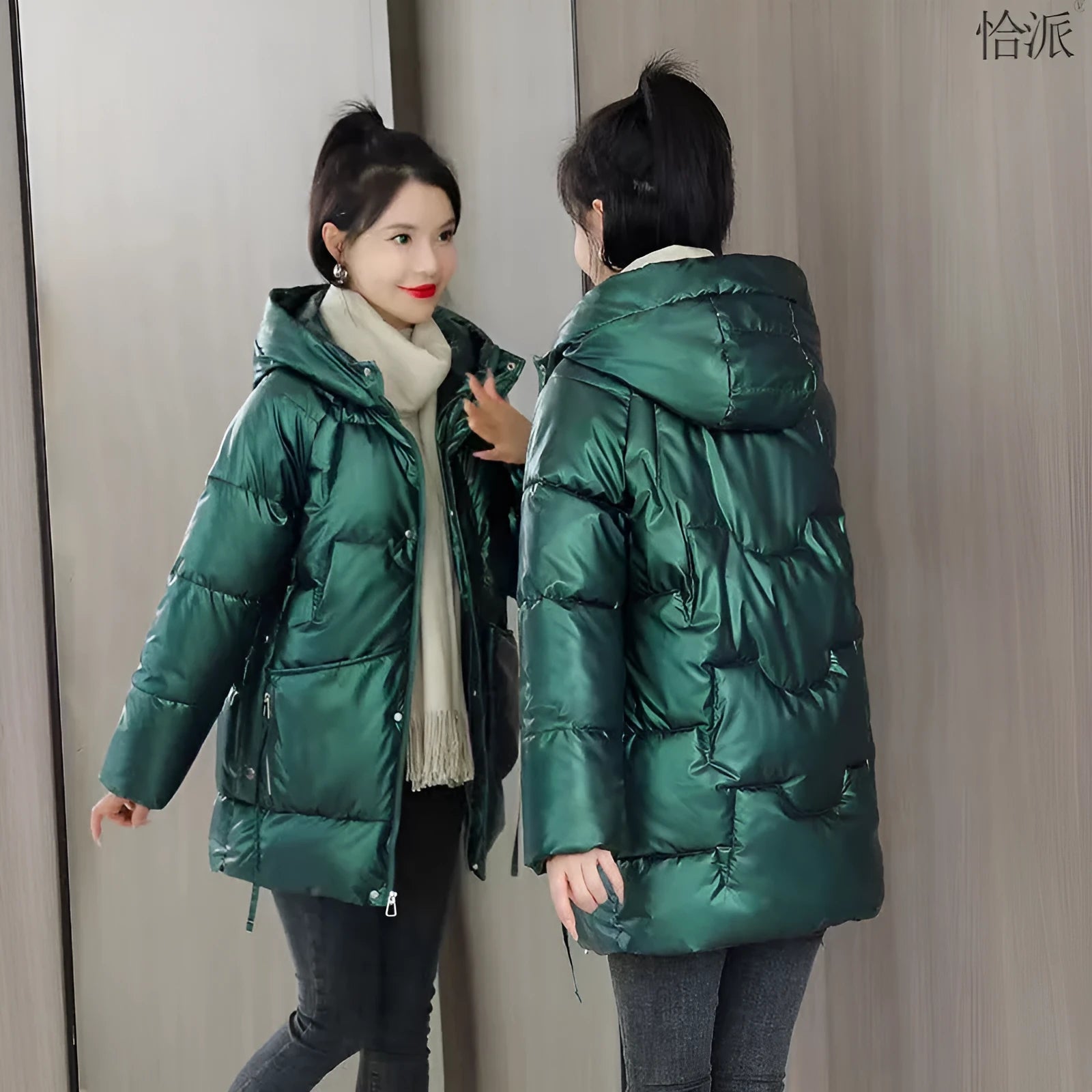 Green loose-fit women's hooded winter jacket with long sleeves on a hanger