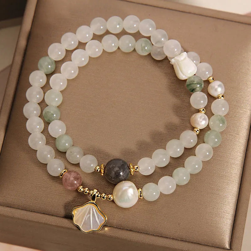 Women's crystal bracelet with Tianshan Jade ginkgo leaf pendant and gold-plated inlay.