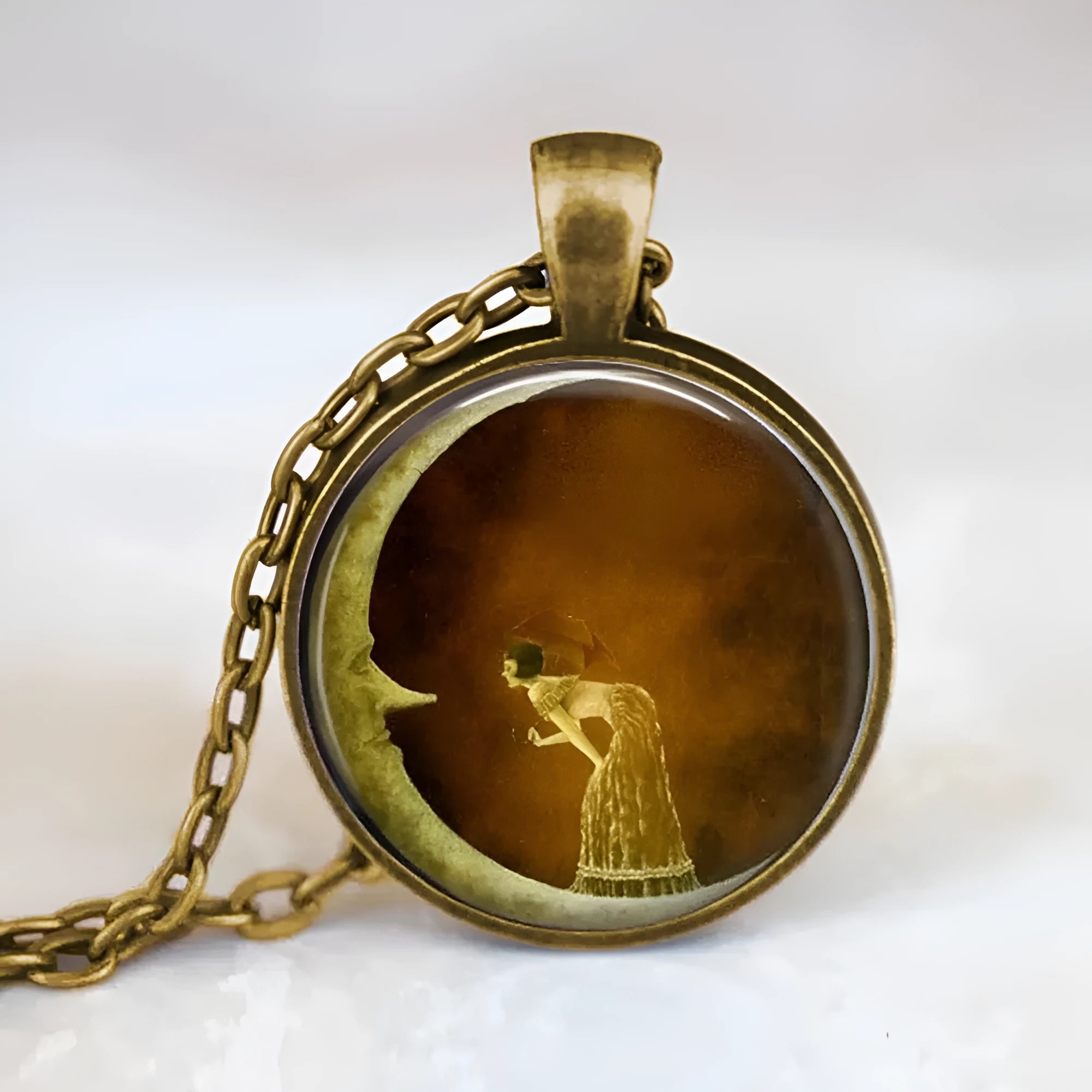 Retro moon-shaped organic glass pendant necklace on adjustable alloy cross chain in bronze finish