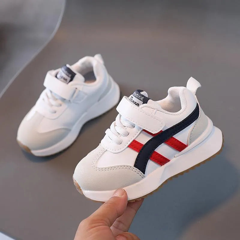 Children's solid-colour Velcro sneakers in synthetic leather with rubber soles, shown in beige.