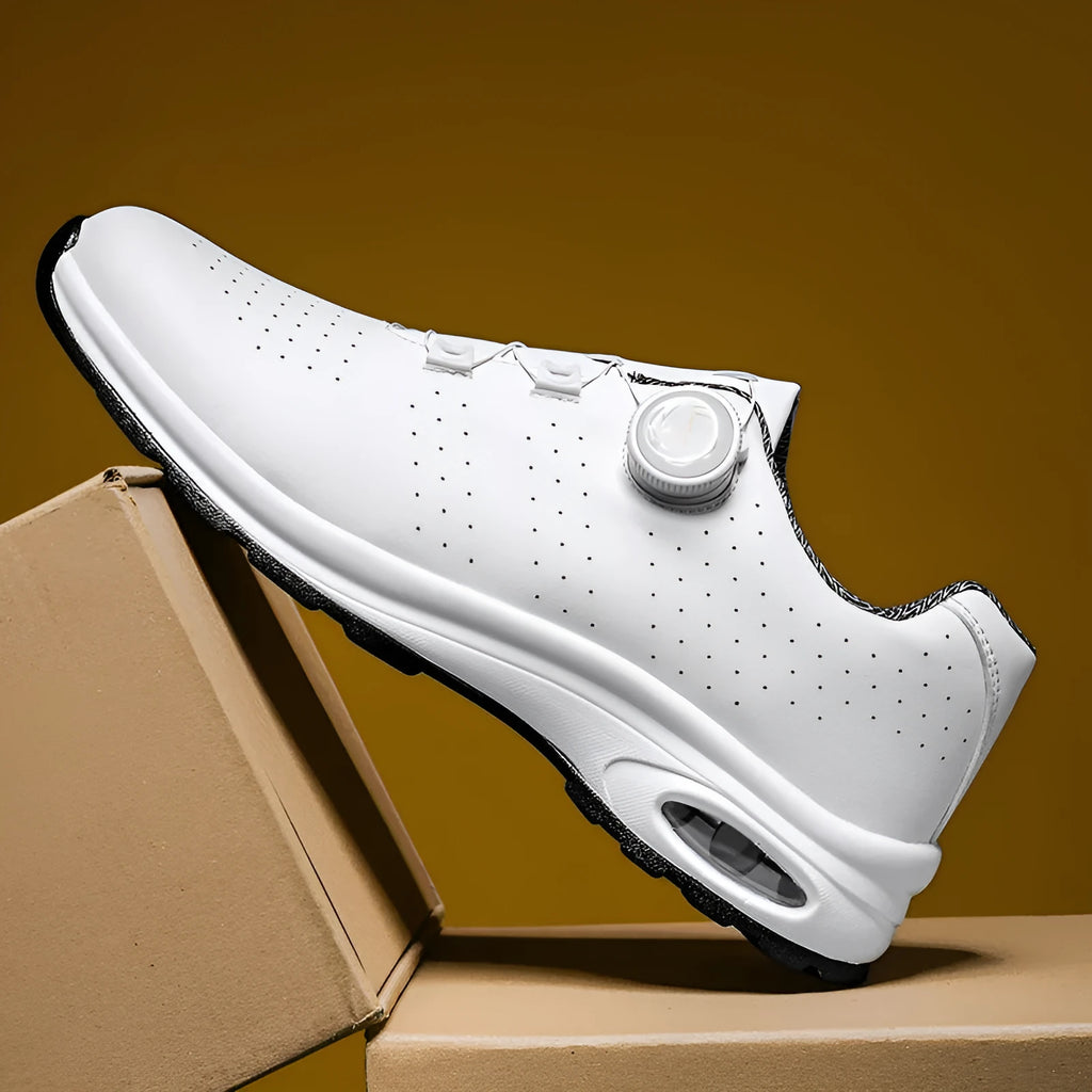 Man's black and white low-top casual tennis shoes with mesh upper and cross shoulder straps.