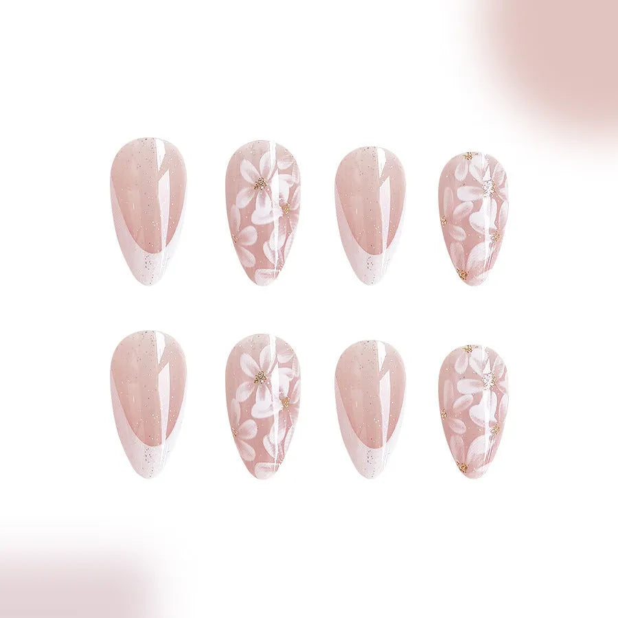 Short almond shaped false nails with glossy finish, glitter, and powder flower design in C625 colour.