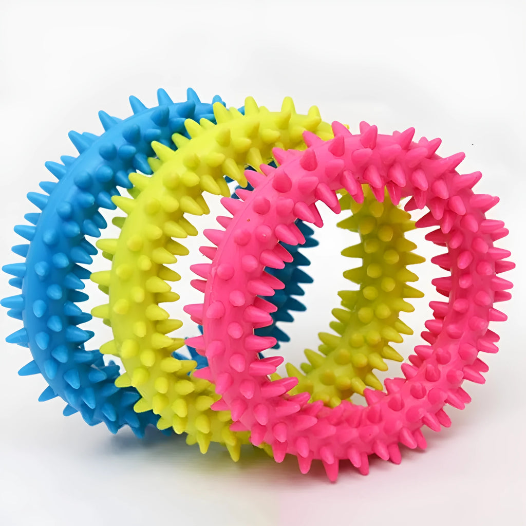 Blue TPR spiky circle ring dog chew toy for teeth cleaning on a white background.