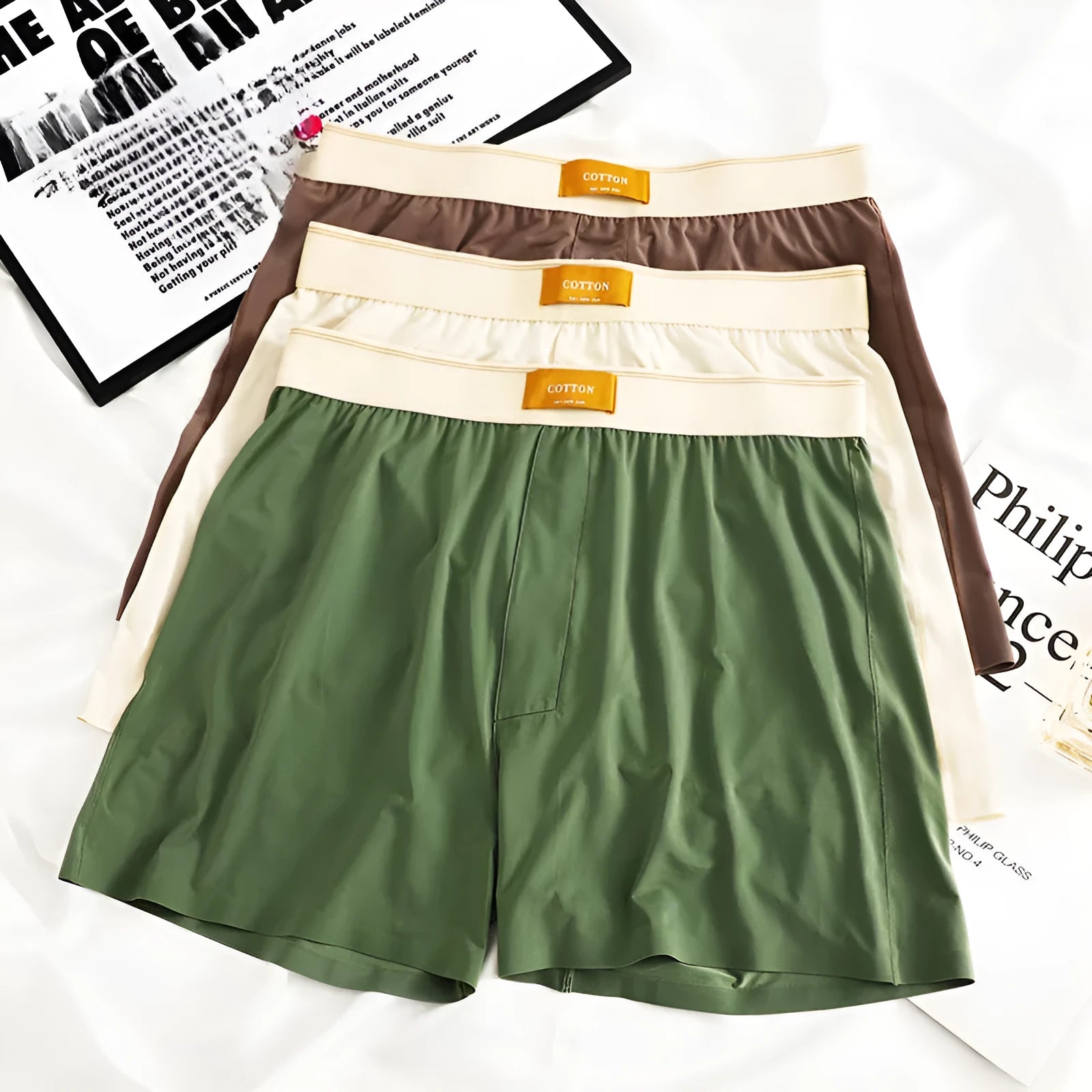 Men's solid colour loose fit ice silk underwear in a multi-pack on a grey background.