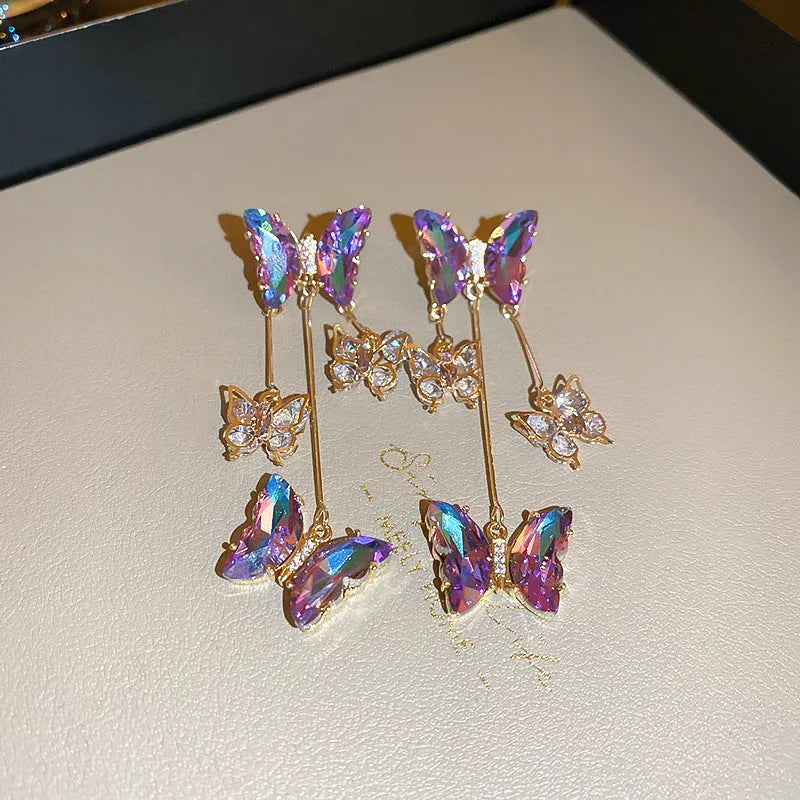 Silver Needle blue purple butterfly tassel earrings with crystal flowers on alloy chains, showing 7cm drop length.