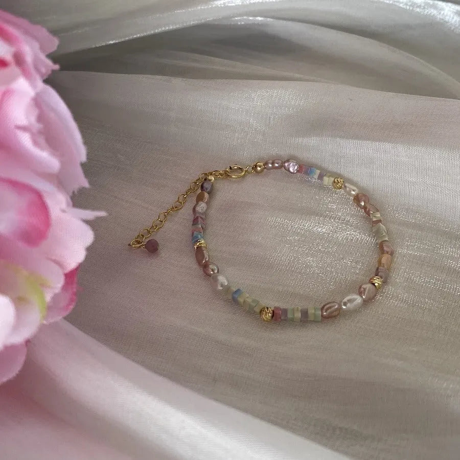 Women's natural pearl bracelet and necklace set with a purple and gold-plated clasp on a silver chain.