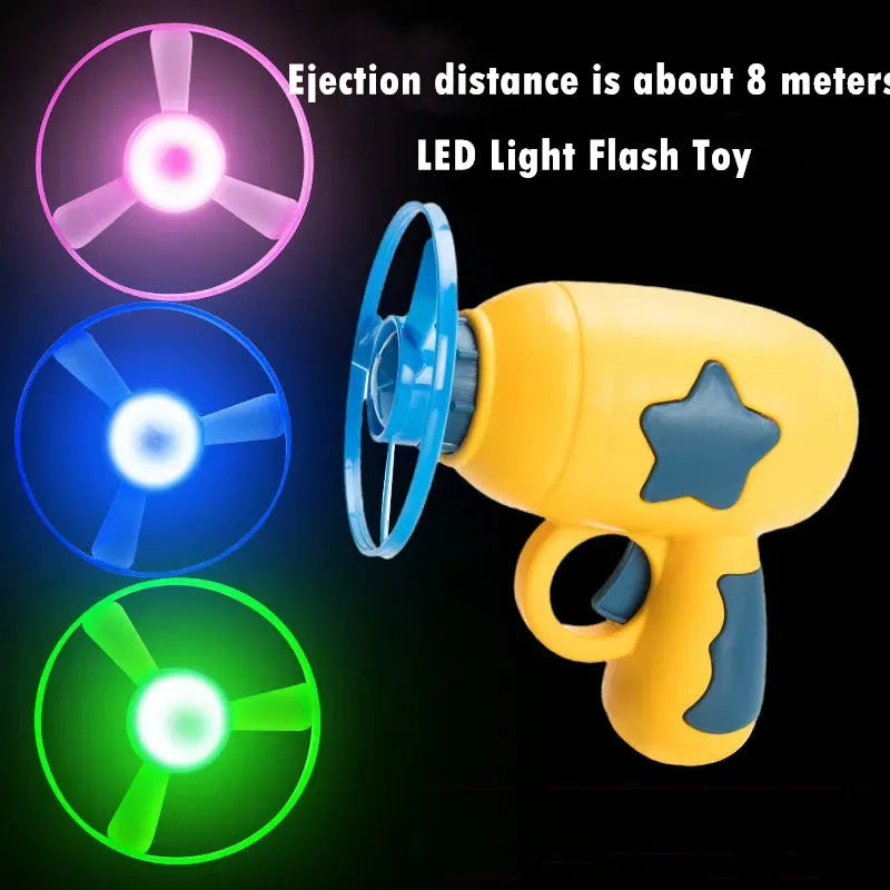 Blue LED flying saucer launcher toy set with gun, three luminous discs, and target board on packaging.