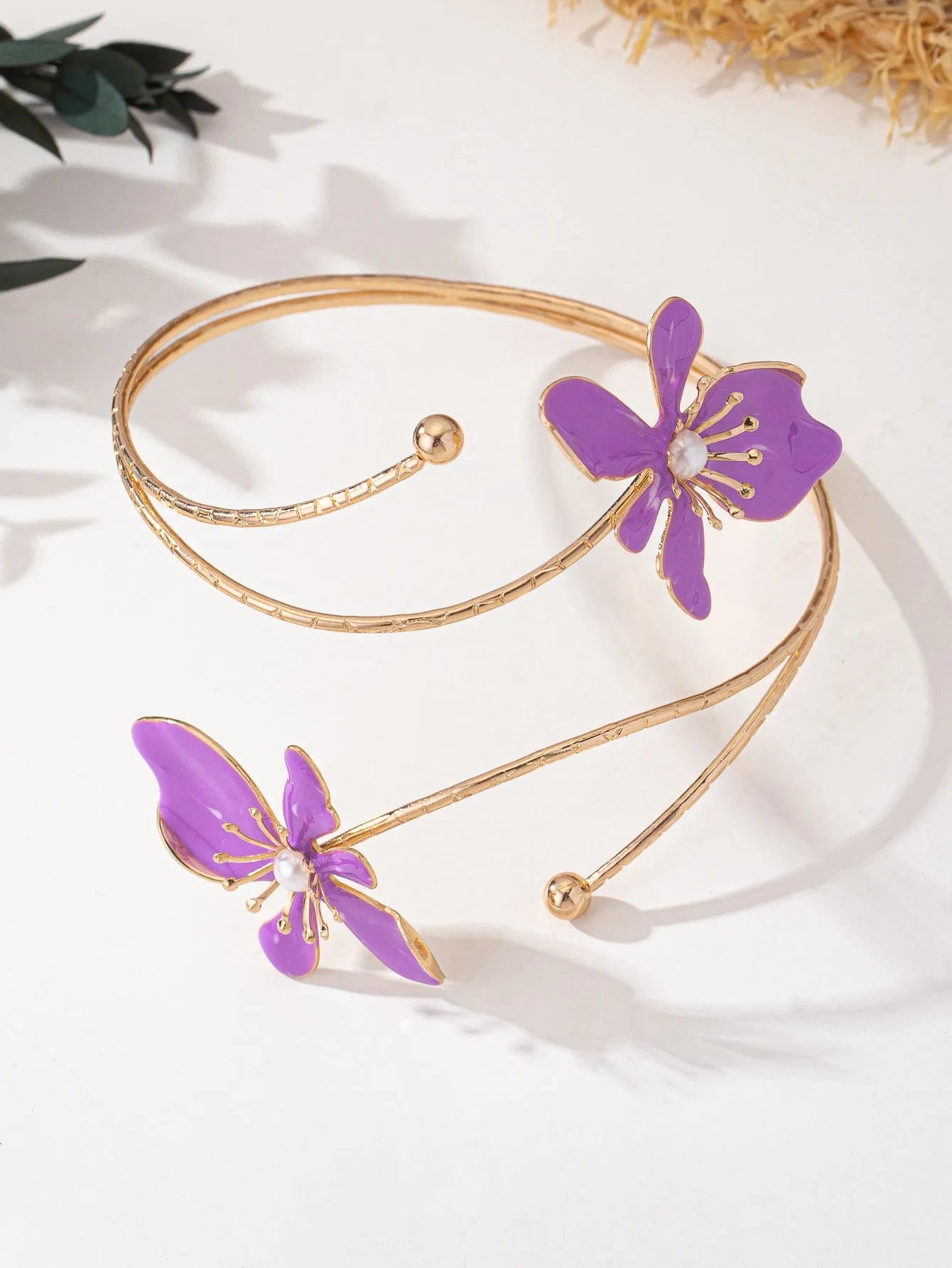 Pink hollow-out pattern alloy armband with adjustable lines on a wrist.
