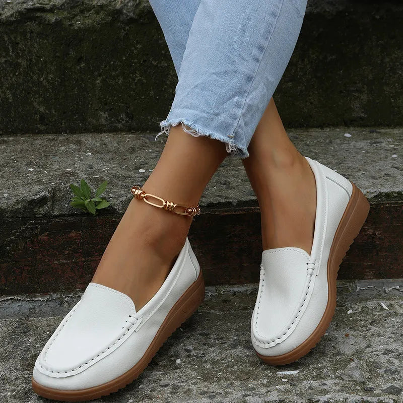 Women's black PU leather flat shoes with round toe and rubber sole on a white background.
