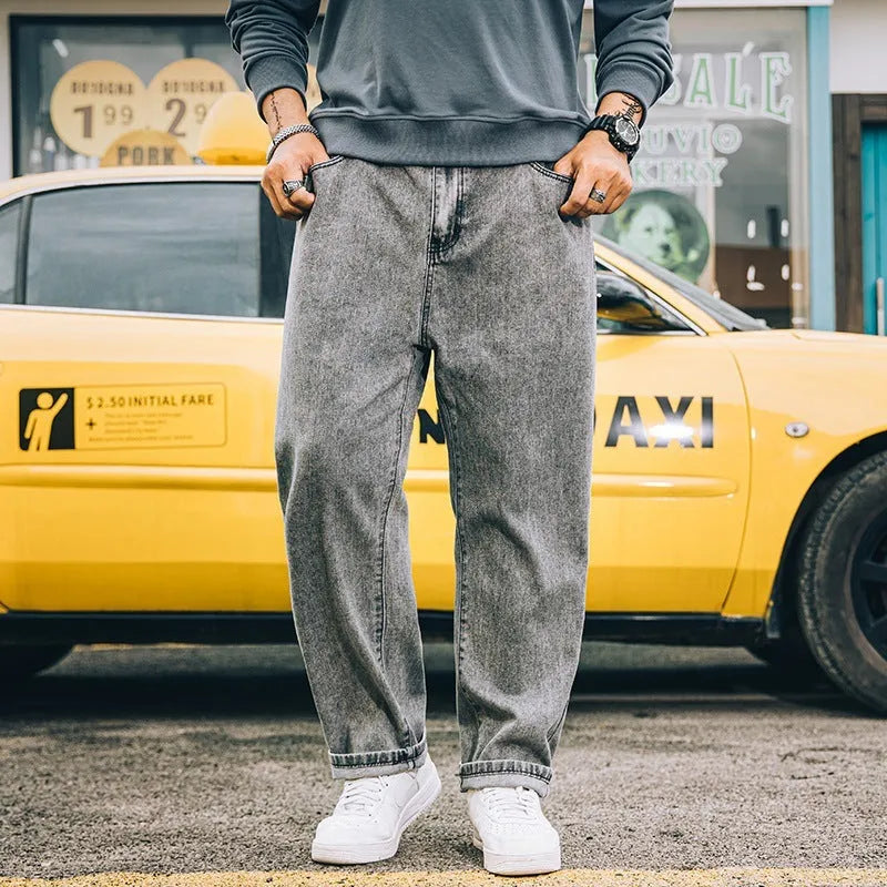 A pair of men's loose-fitting straight-leg casual jeans in dark blue cotton fabric.