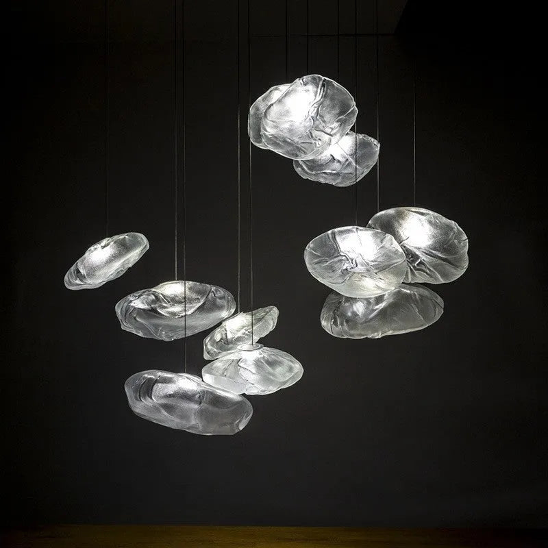 Modern light luxury glass chandelier in amber, clear, and smoke grey colours for lounge lighting.