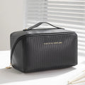 Large beige cubic PU leather makeup bag with vertical pattern, shown open.