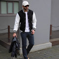 Men's cotton blend solid colour baseball jacket in black, loose fit, front view on model