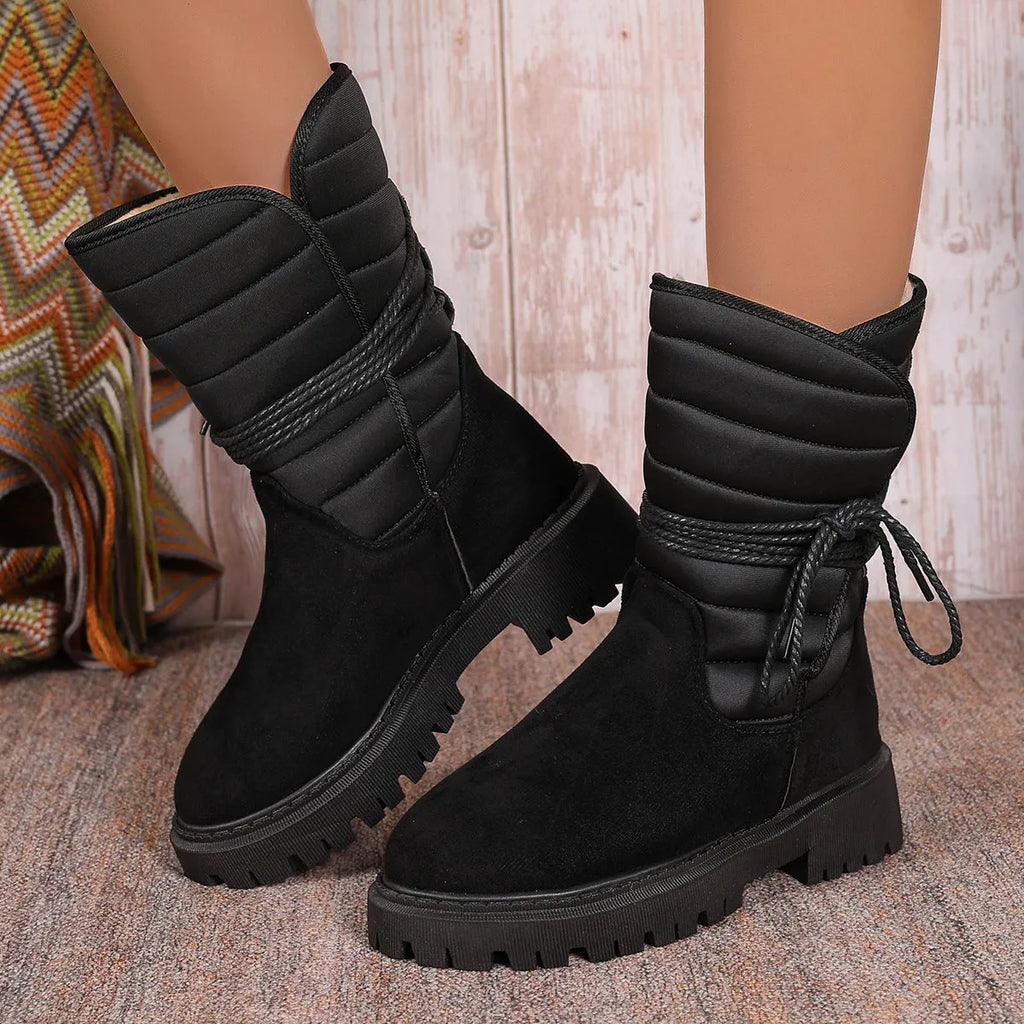 Women's black suede chunky heel snow boots with lace-up front and fleece lining.