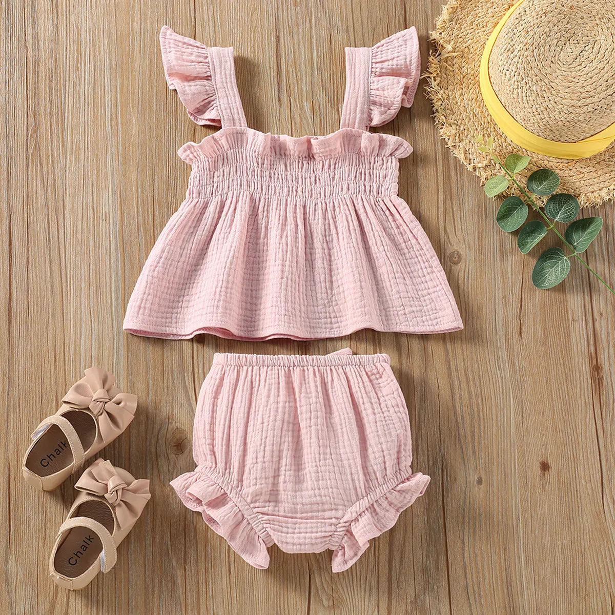 Green cotton girls' two-piece set with sleeveless sling top and matching short hot pants.