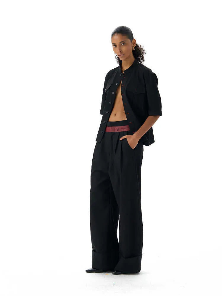 Handmade black loose-fit half sleeve hunting shirt with a shirt collar on a hanger.