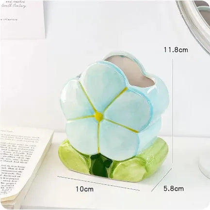 Ceramic flower pen holder storage box in a floral design on a desk