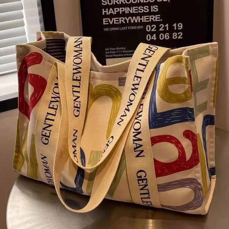 Large canvas women's tote bag with printed design options including letters and patterns