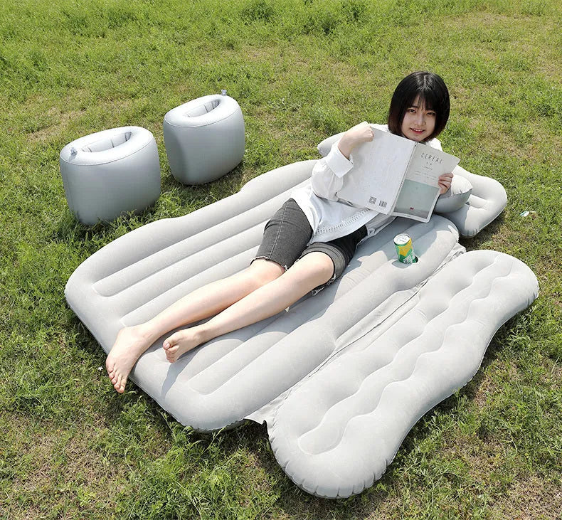 Inflatable car boot mattress with split design and grey flocked fabric, shown in an SUV rear.