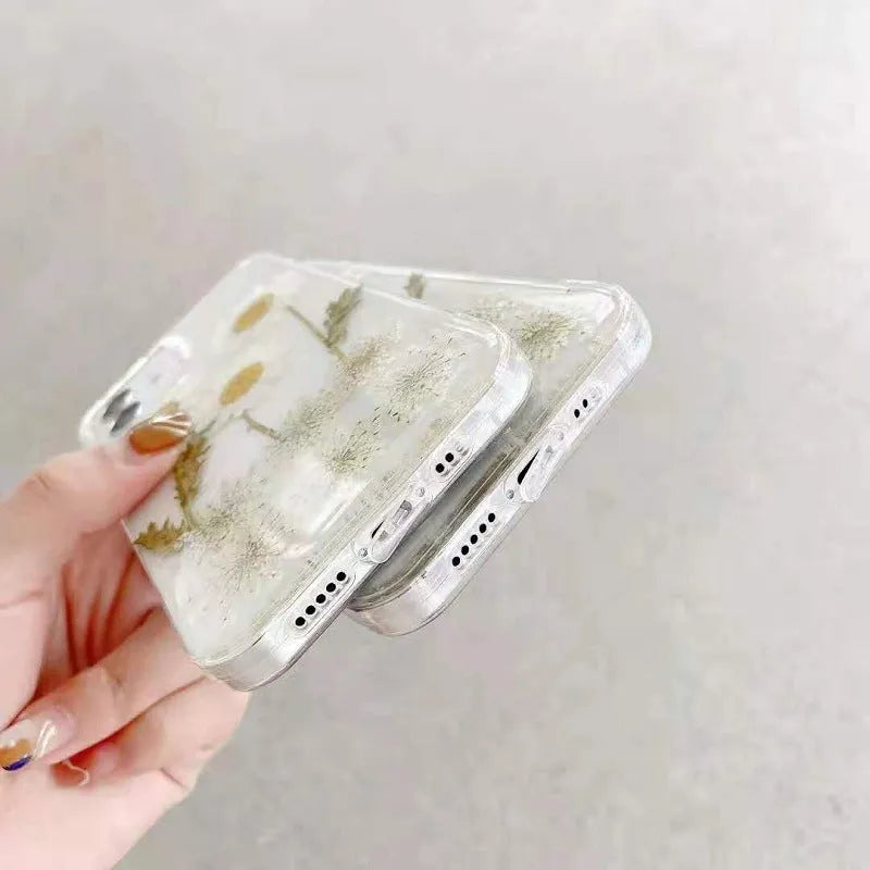 White iPhone case with a raised epoxy daisy floral design on the back.