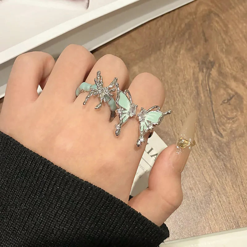 A copper women's ring with a butterfly design and a unique dripping oil textured finish.