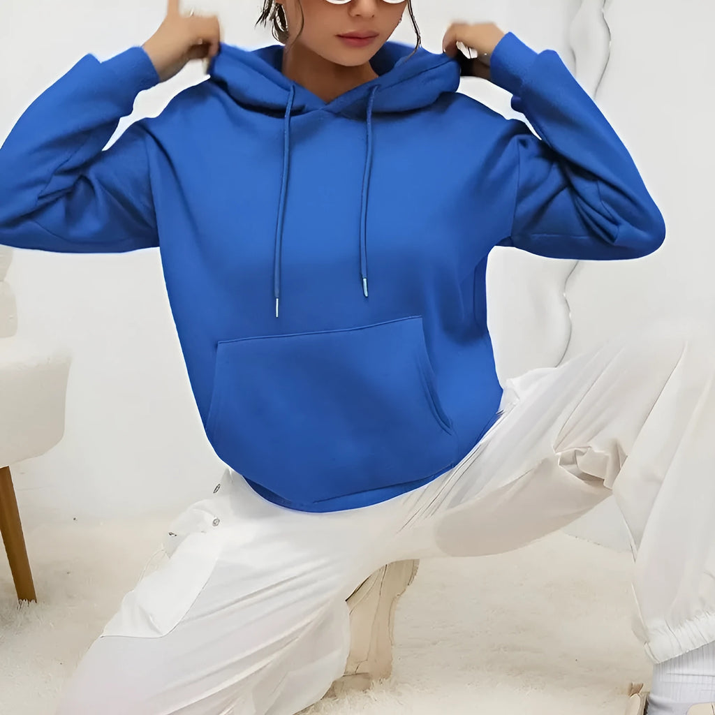Women's loose grey drawstring pocket sweatshirt on a hanger showing front detail.