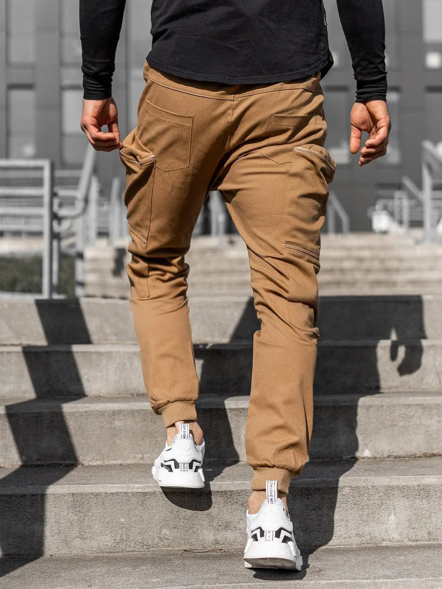 Men's tight fit multi-pocket cotton trousers in black, shown with multiple front pockets and tethered details on waistband.
