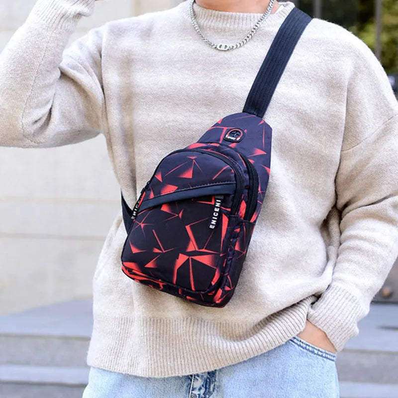 Men's blue print sling chest bag with a visible earphone hole and a single adjustable strap.