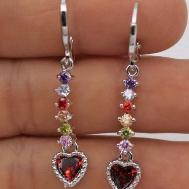 A pair of women's heart-shaped earrings with an electroplated gold or silver finish on an alloy base.