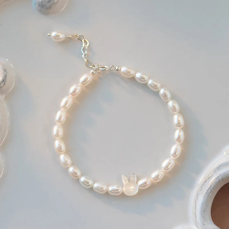 Handmade women's rabbit bracelet with 925 silver charm and white shell pearl beads on elastic string