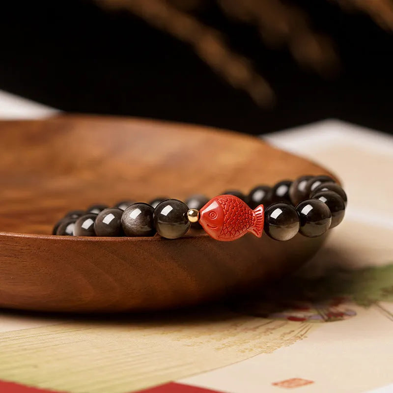 Natural obsidian bracelet with cinnabar fungal growth in round beads, showing stone patterns