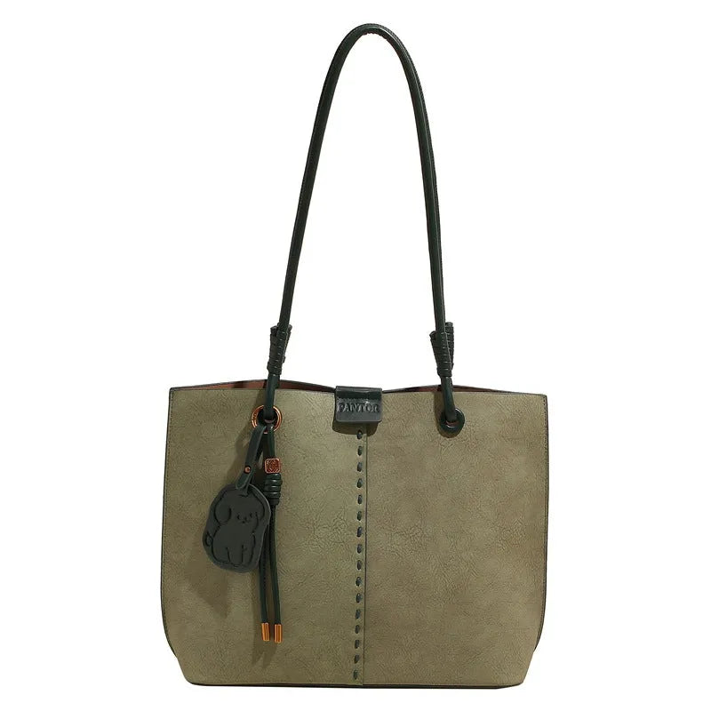 Green urban minimalist PU shoulder bag with stitching detail and double straps on a white background.