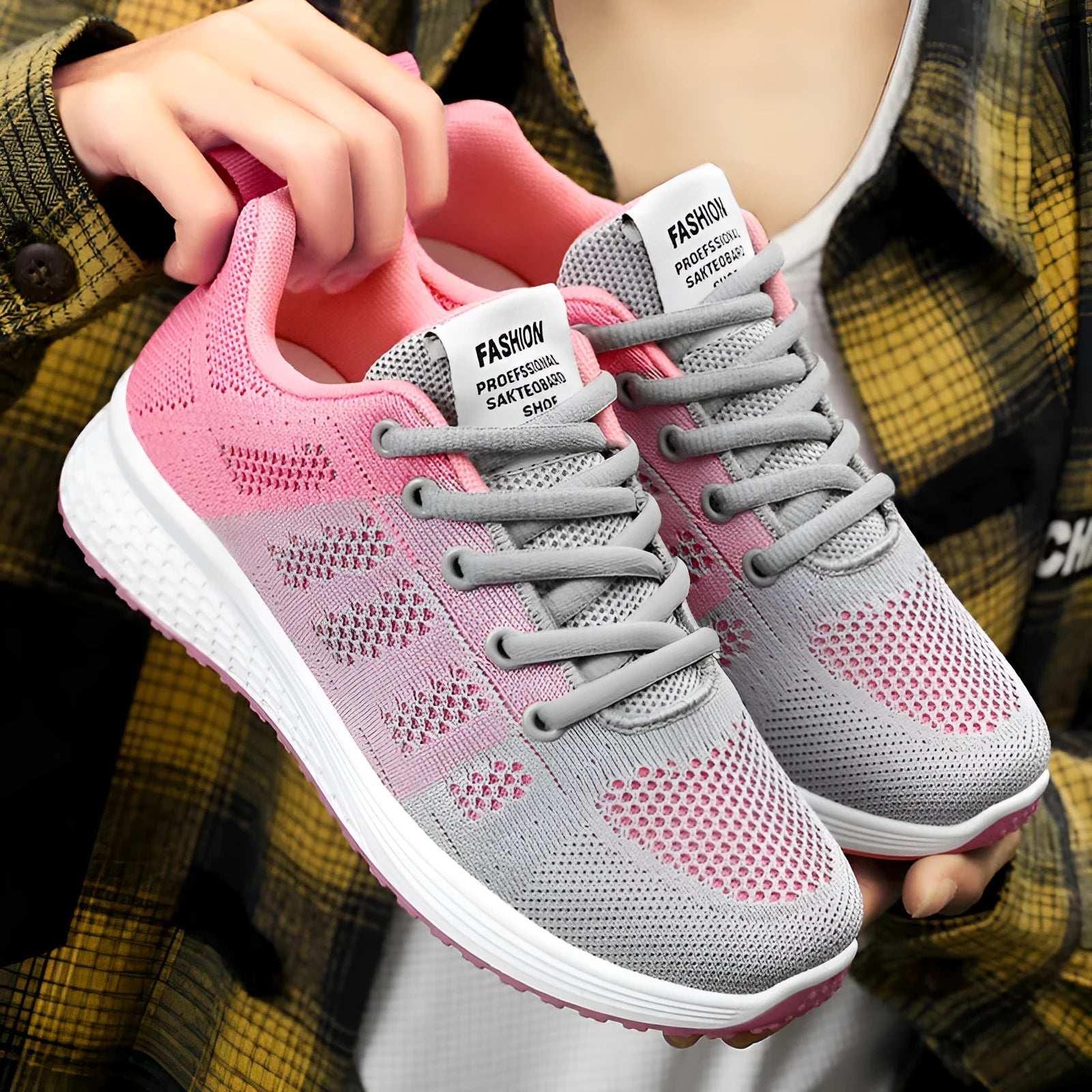Women's Flyknit running shoes in black, rose red, and grey pink on a white background