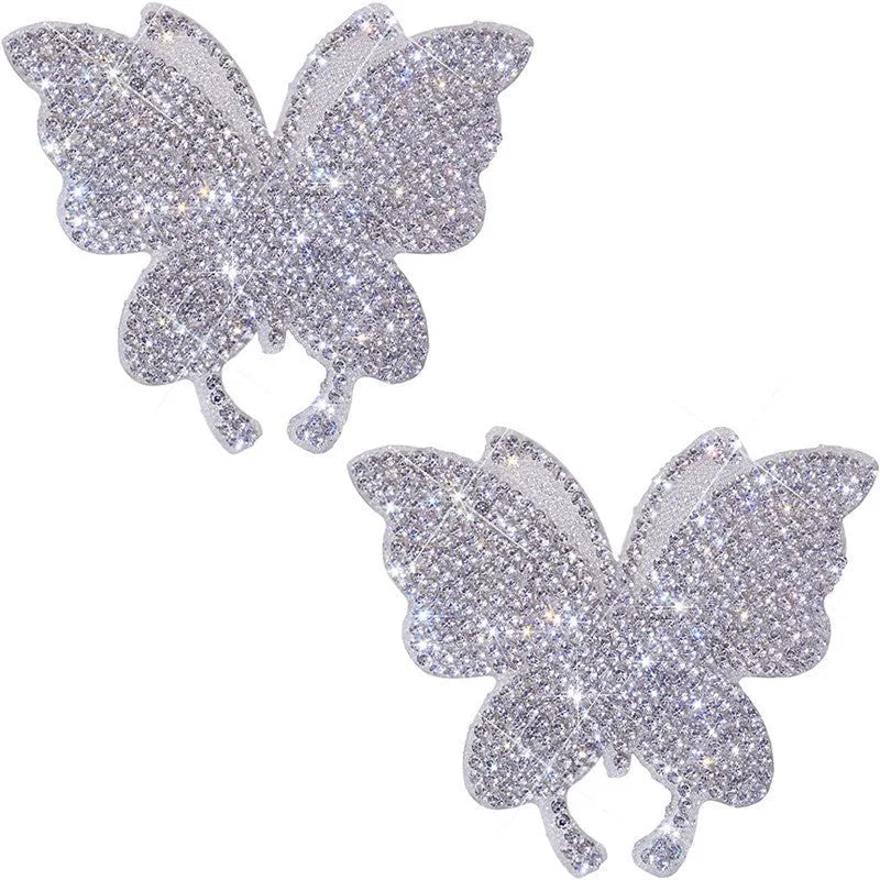 Close-up of a diamond-encrusted glass car sticker in a bear paw design on a car window.