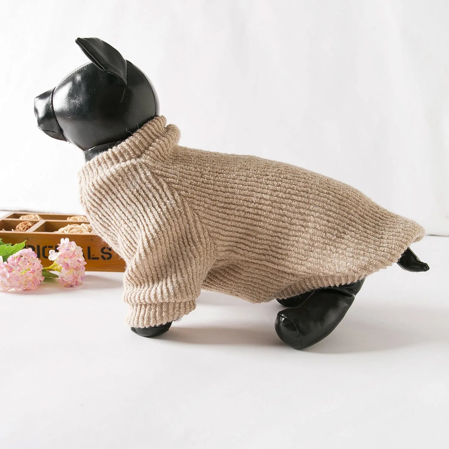 Brown cloth pullover sweater on a small dog, showing casual design.