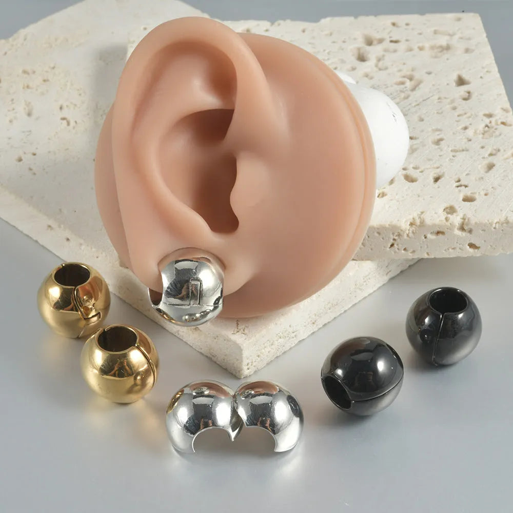 Stainless steel hollow skull Buddha earring in geometric hip hop style.