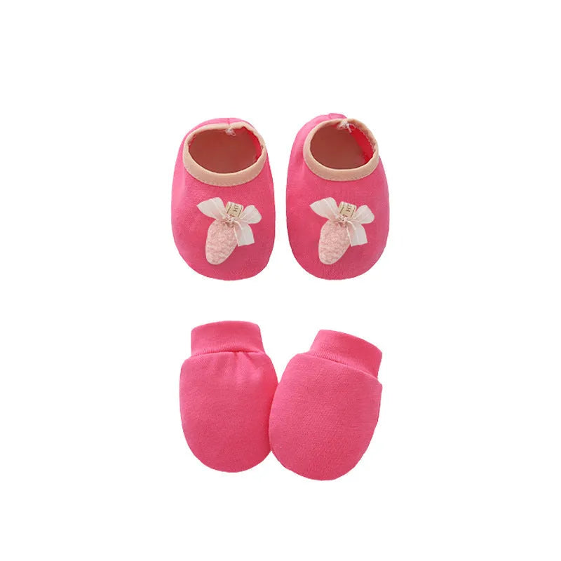 Set of white, light blue, and grey cotton baby pullover caps, gloves, and foot covers for infants.