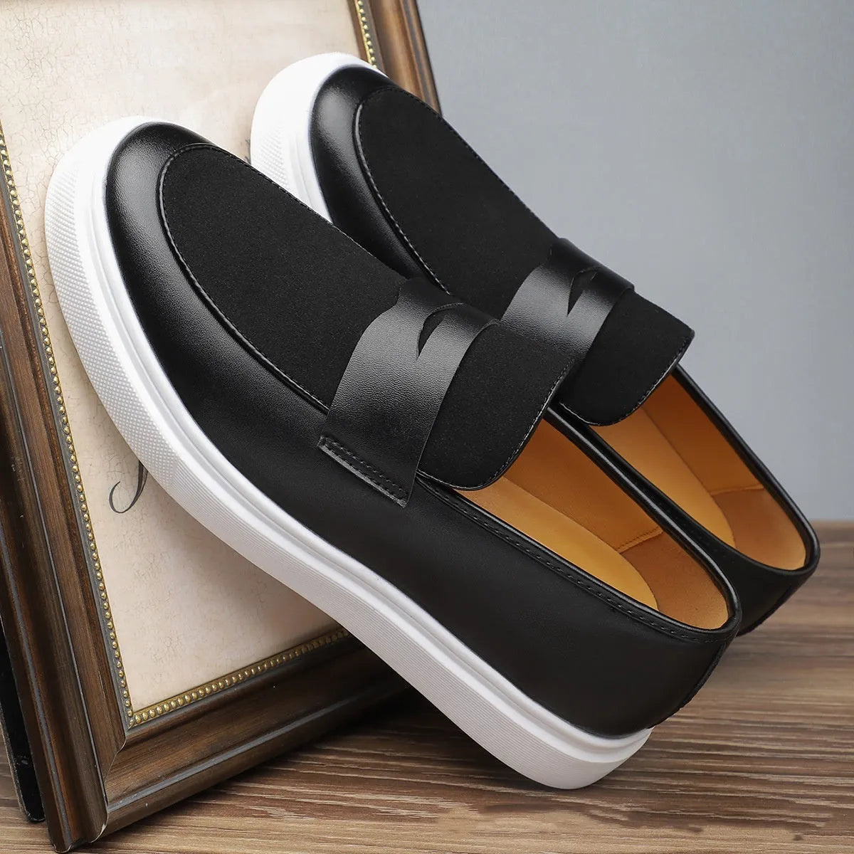 Men's black slip-on casual shoes with tassel detail and round toe