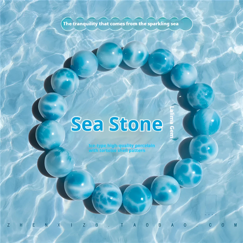 Blue bodhi bracelet with a sea-pattern natural crystal stone and small pearl accents on a wrist.