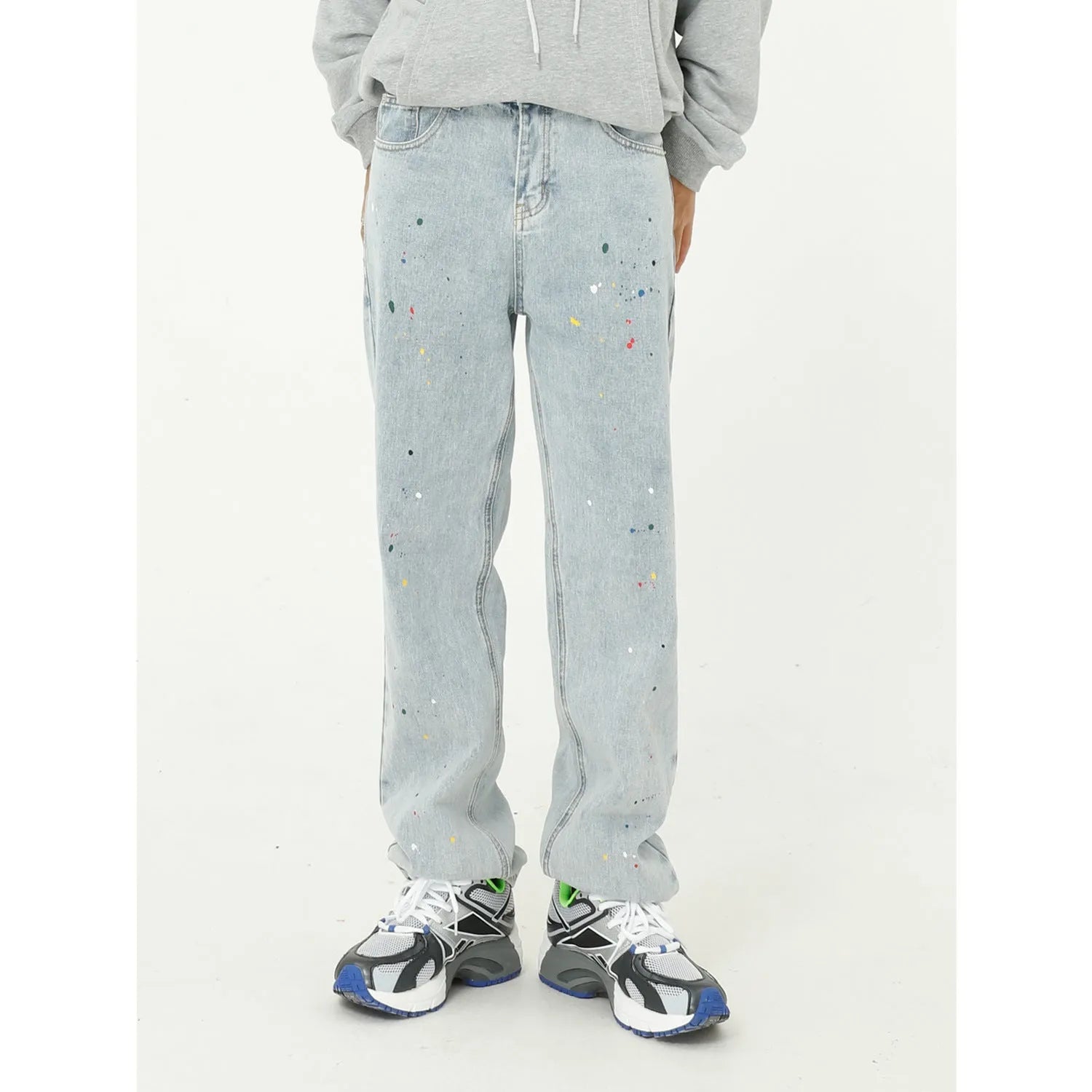 Light blue straight loose jeans with paint splash and washed finish, mid-waist zip fly, laid flat on neutral background