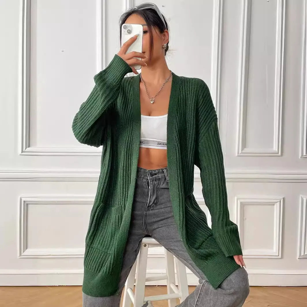 Women's dark green loose cardigan with two front pockets and long sleeves.