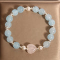 Natural aquamarine crystal bracelet with three shell pearls and lobster clasp on display
