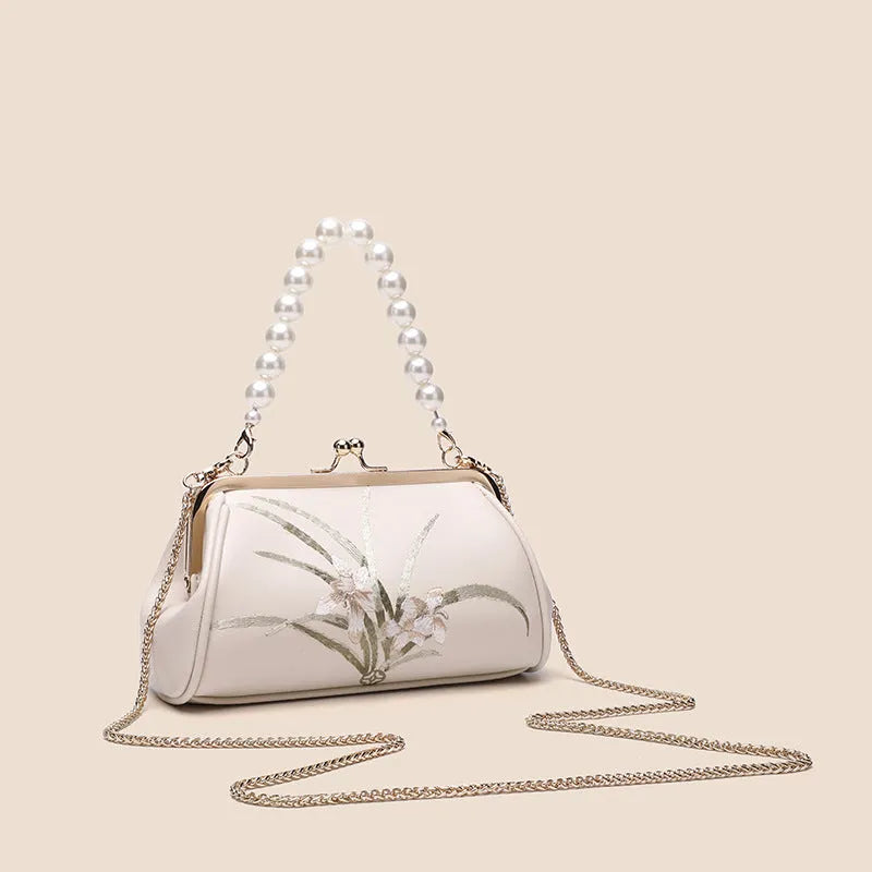 Beige shell-shaped women's shoulder bag with embroidery detail on soft PU leather.