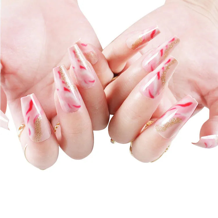 Wearable manicure set showing 24 false nails in various patterns with glue bottle