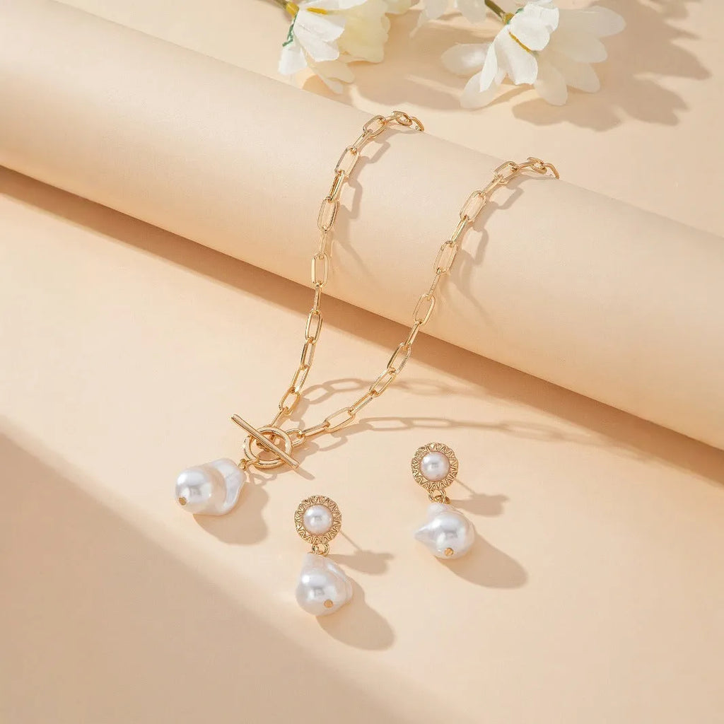 Gold colour baroque pearl pendant necklace and matching stud earrings set.