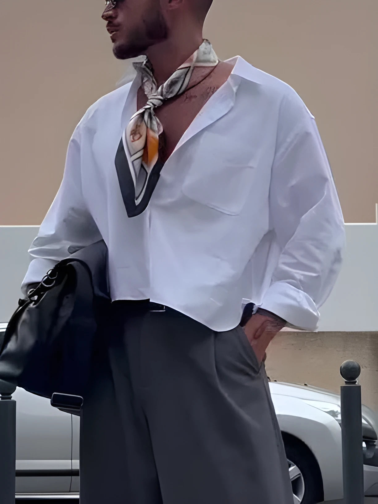 White men's casual polyester shirt with cropped top length on a hanger