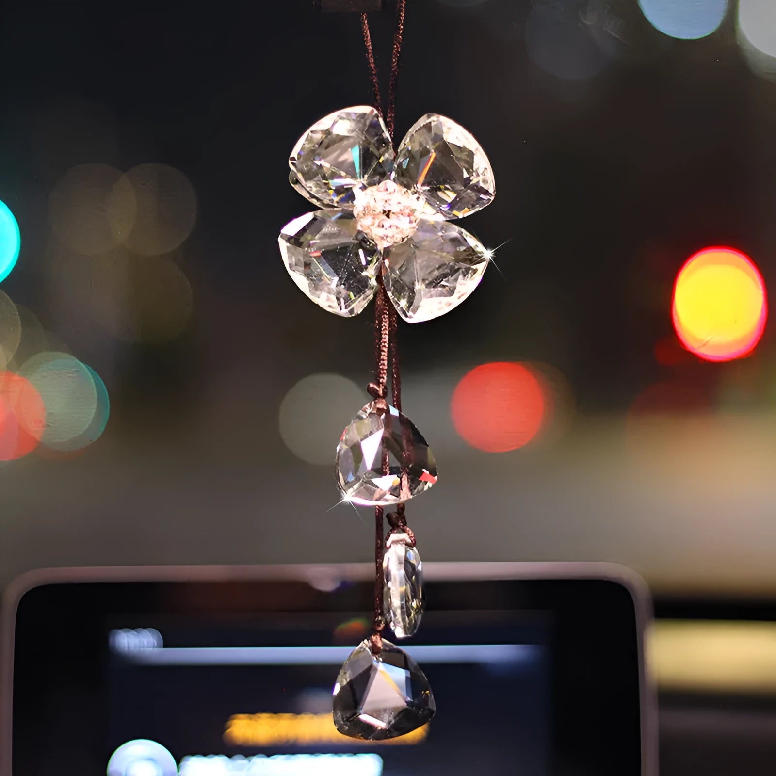 Crystal four leaf grass car pendant hanging, shown in different colour options including transparent and champagne.